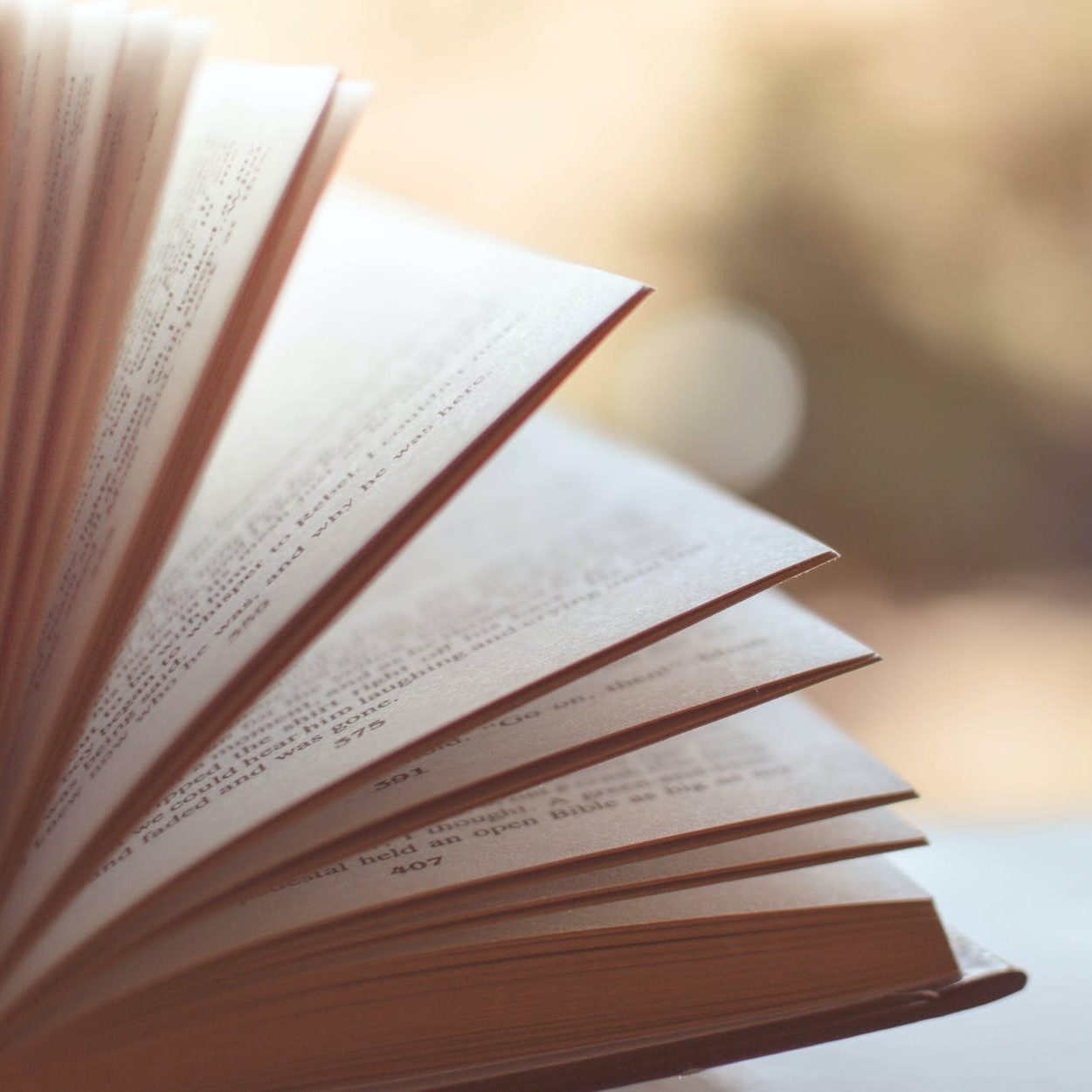 book opened on white surface selective focus photography